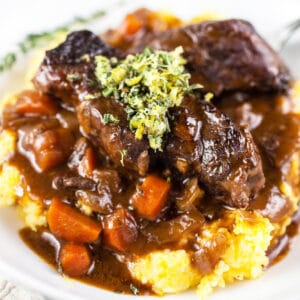 Braised beef Italian short ribs with lemon rosemary gremolata on polenta.