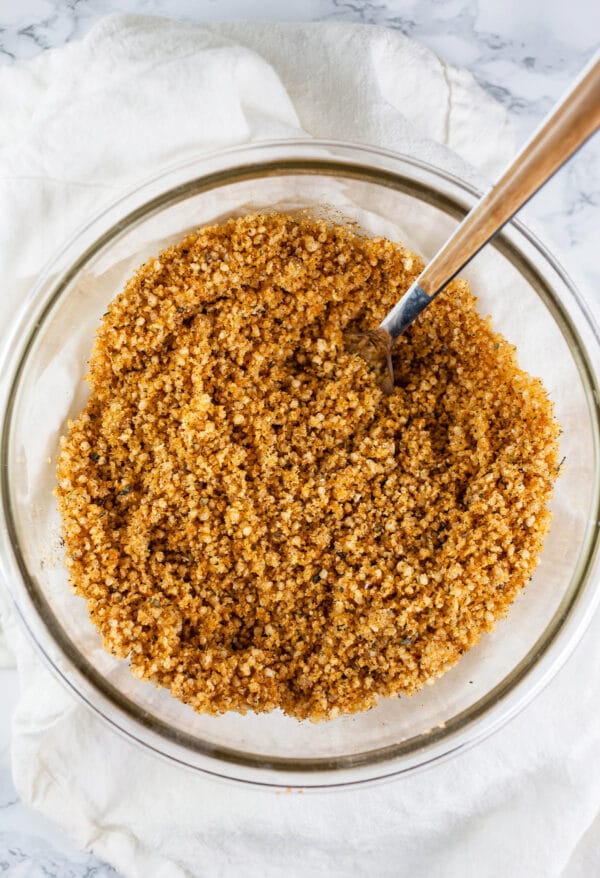 Panko breadcrumb mixture in small glass bowl with fork.