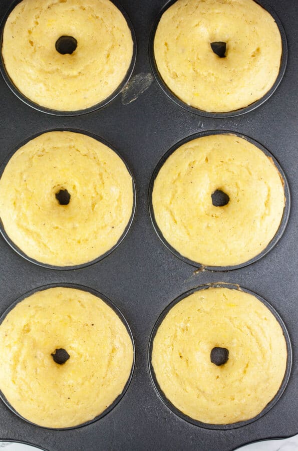 Baked lemon doughnuts in doughnut pan.
