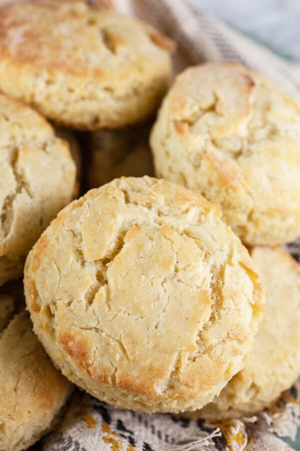 Gluten free biscuits in bowl with decorative towel.