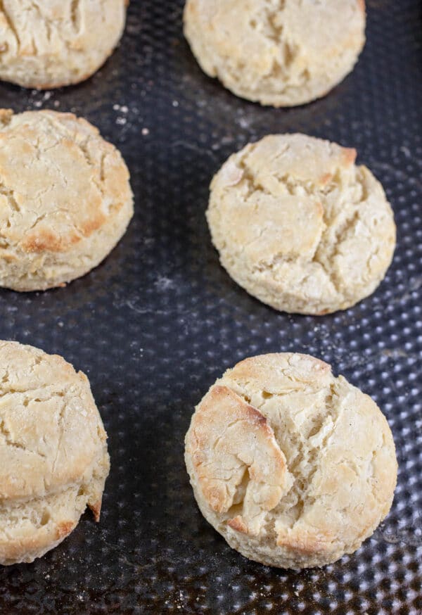 Baked biscuits on metal baking sheet.