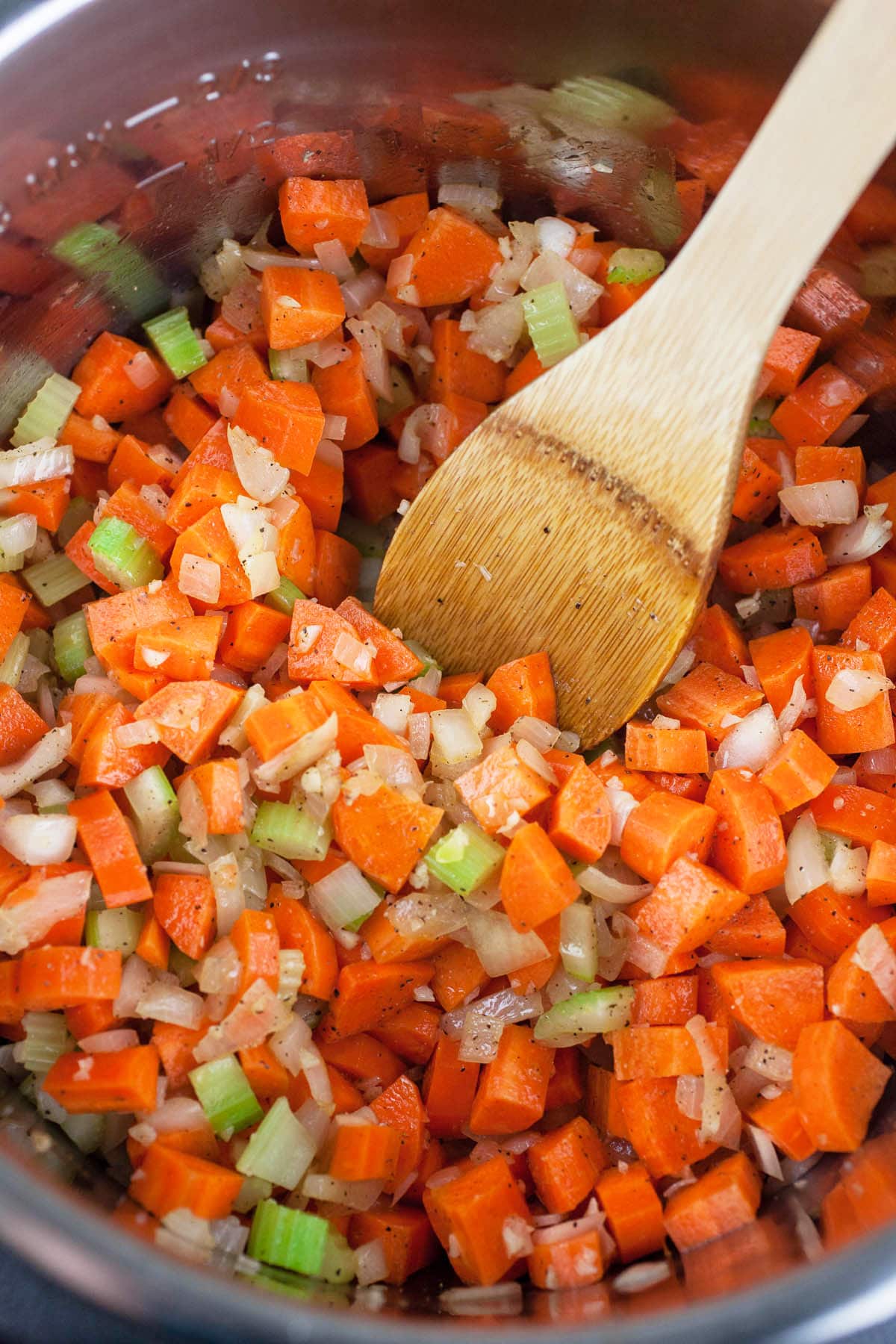 Garlic, onions, celery, and carrots sautéed in Instant Pot.