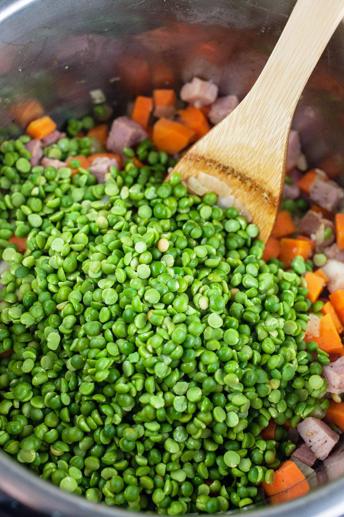 Garlic, onions, celery, carrots, ham, and green split peas sautéed in Instant Pot.