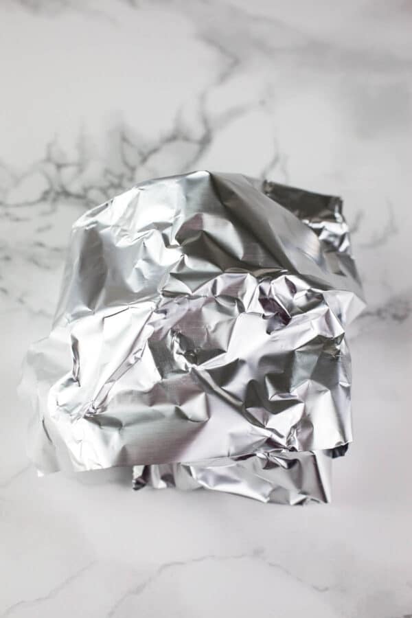 Garlic bulb wrapped in tinfoil.
