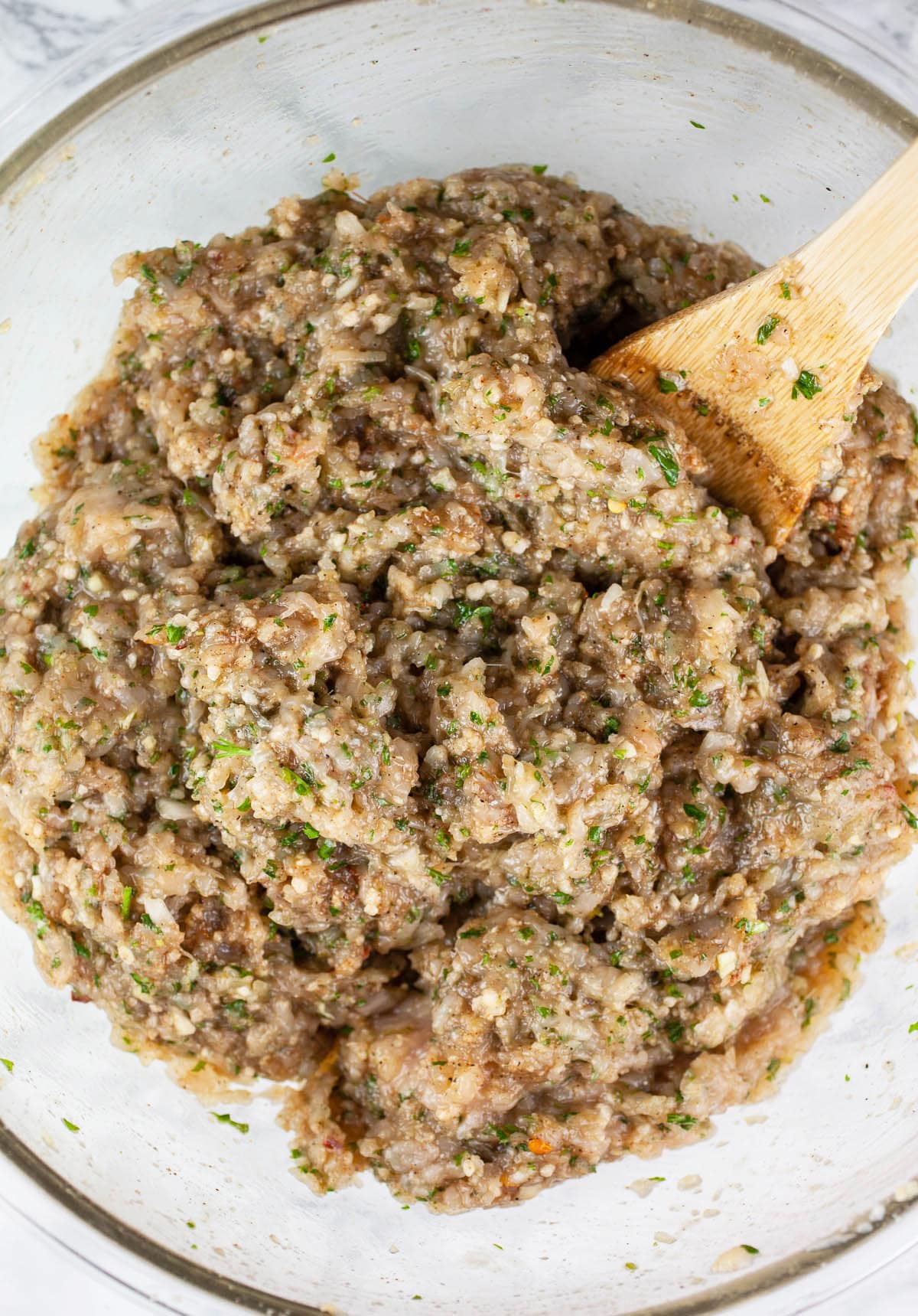 Ground chicken kofta mixture in large glass mixing bowl.