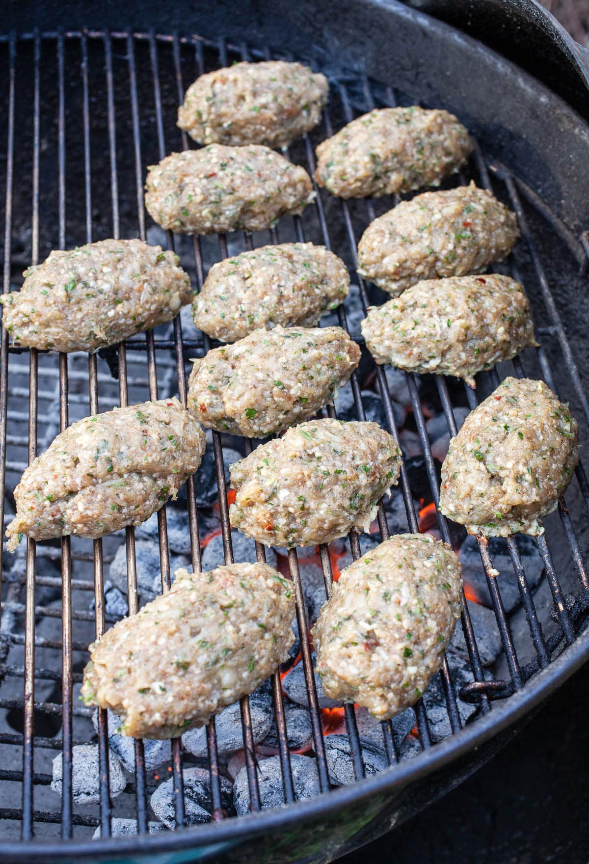 Ground chicken kofta cooking on Weber grill.