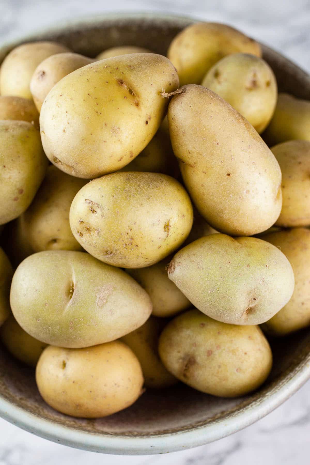 Yukon gold potatoes in ceramic bowl.