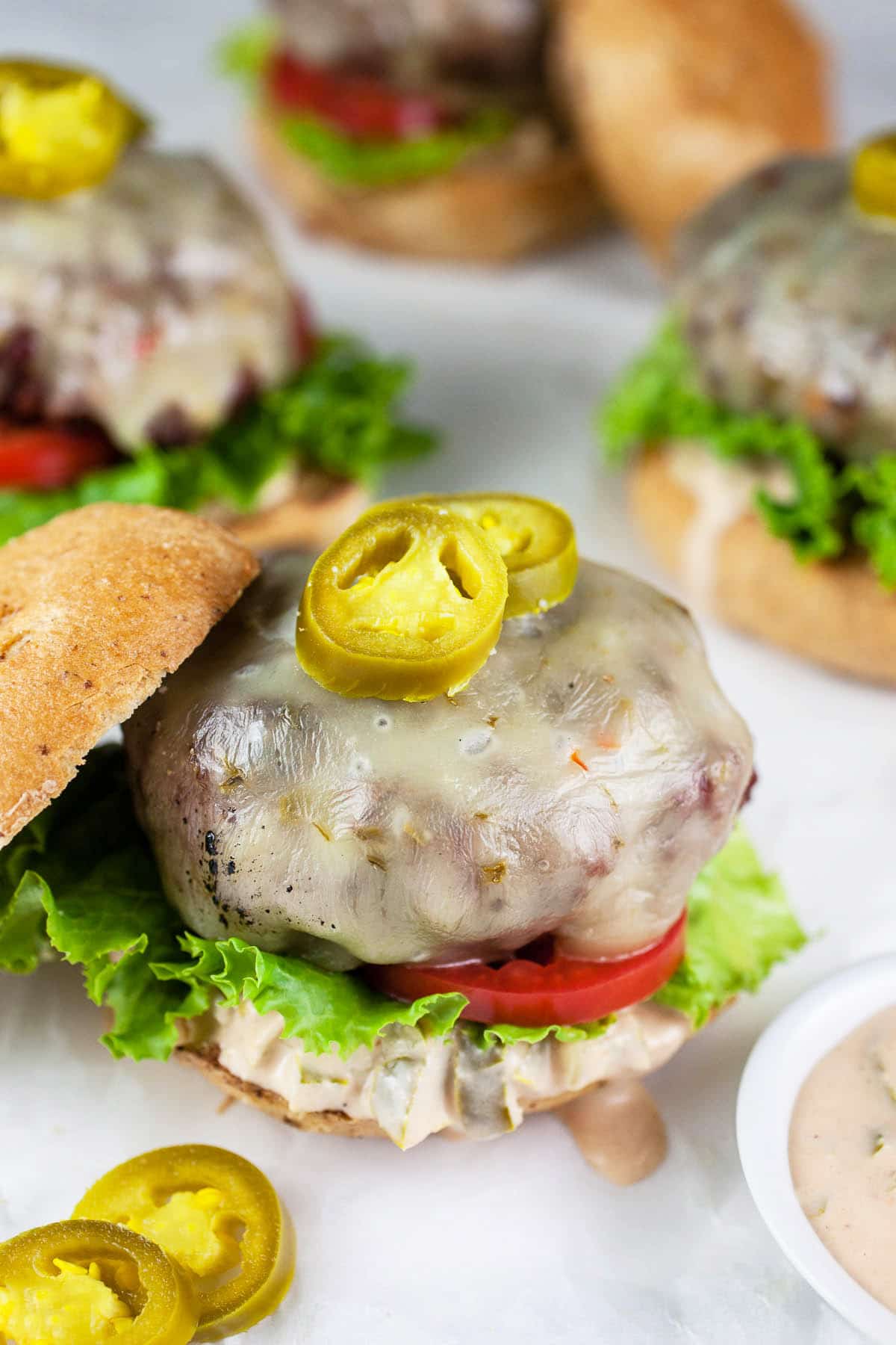 Open faced grilled burgers with jalapeno sauce.