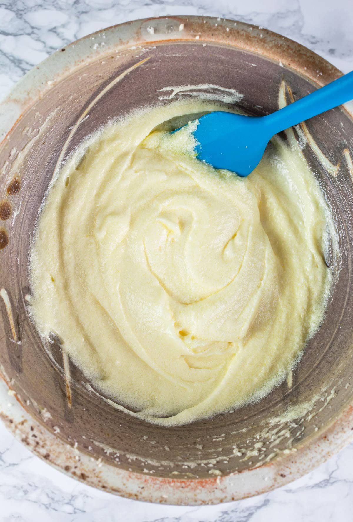 Butter and sugar creamed in ceramic bowl.