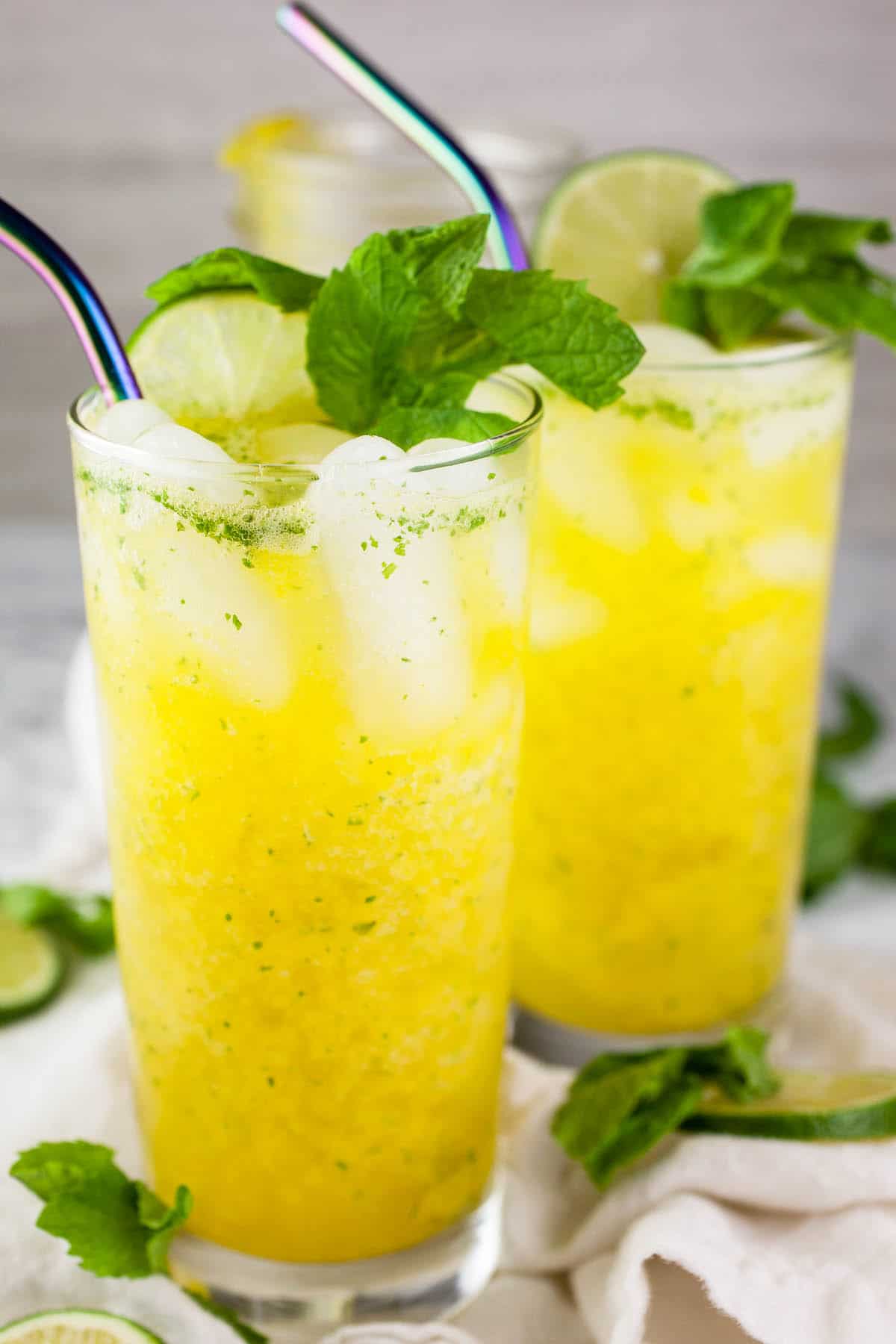 Mango mojito mocktails with fresh mint and lime.