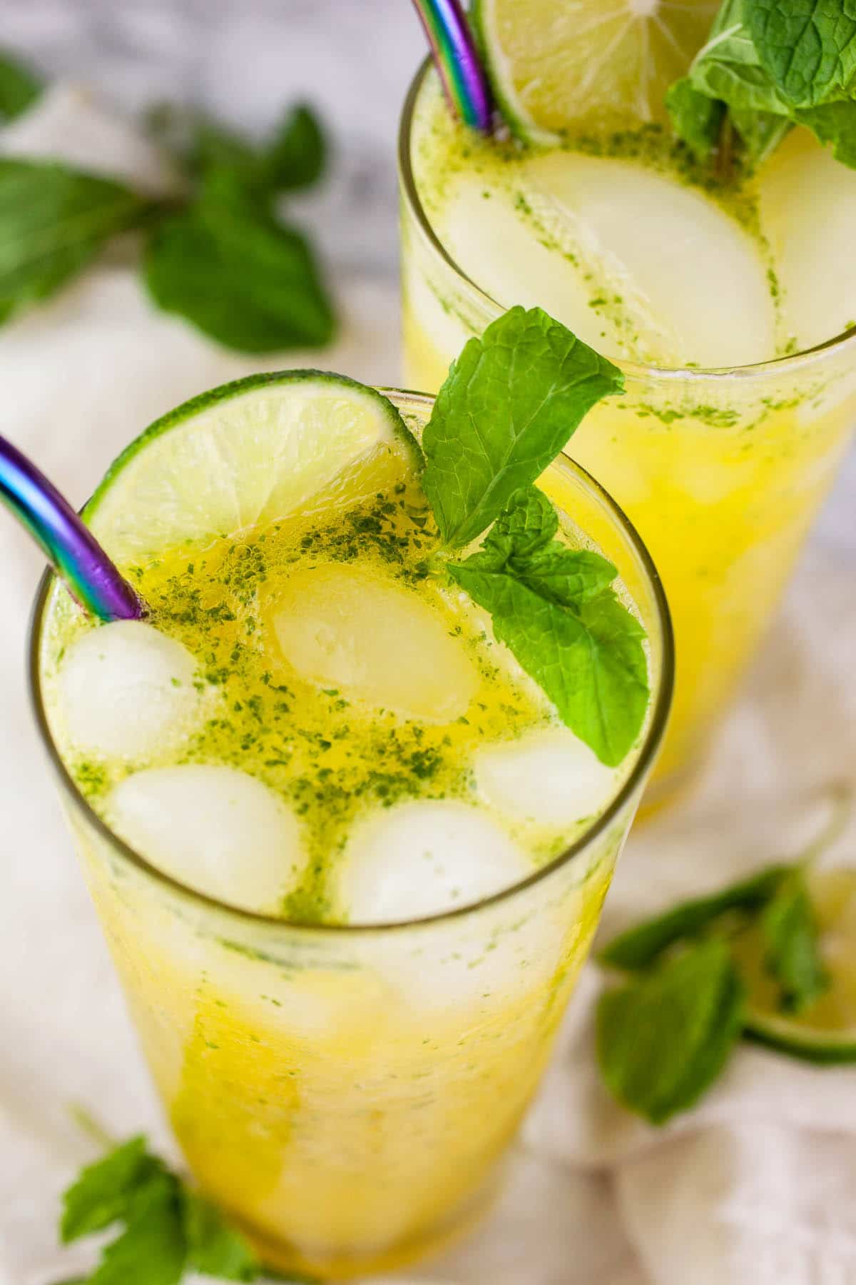 Virgin mango mojito in tall glass with straw.