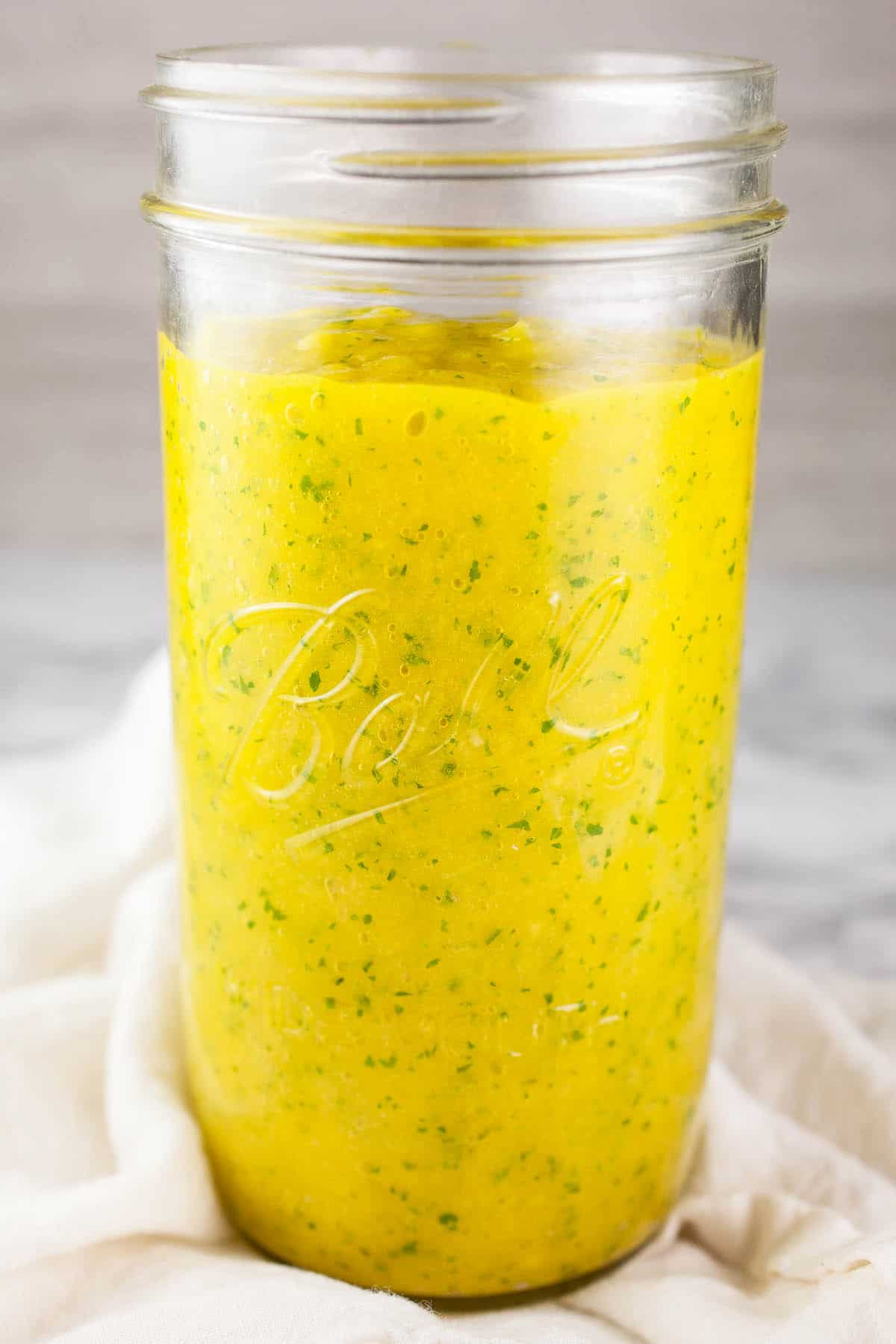 Mango puree in tall glass mason jar.