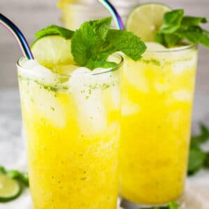 Mango mojito mocktails with fresh mint and lime.