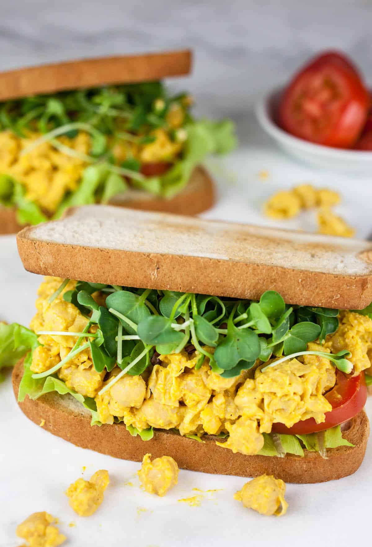 Curried chickpea salad sandwiches with fresh veggies.