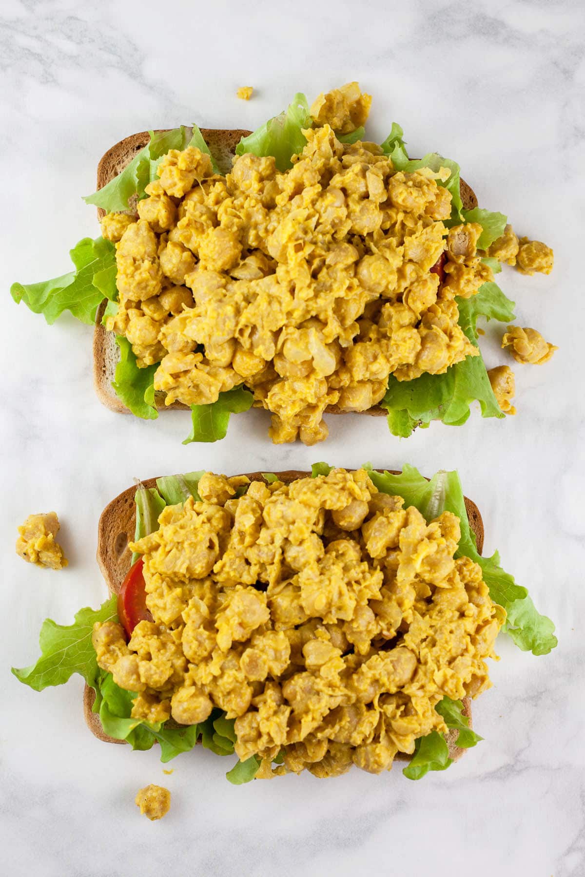 Curried chickpeas, tomato, and lettuce on toasted bread.