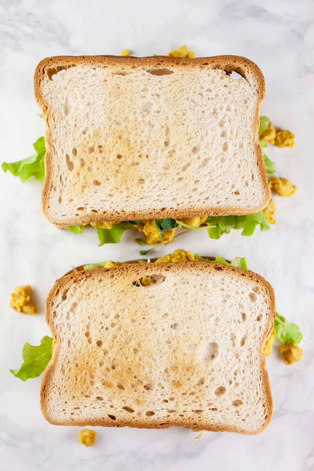 Curried chickpea salad sandwiches with toasted bread.
