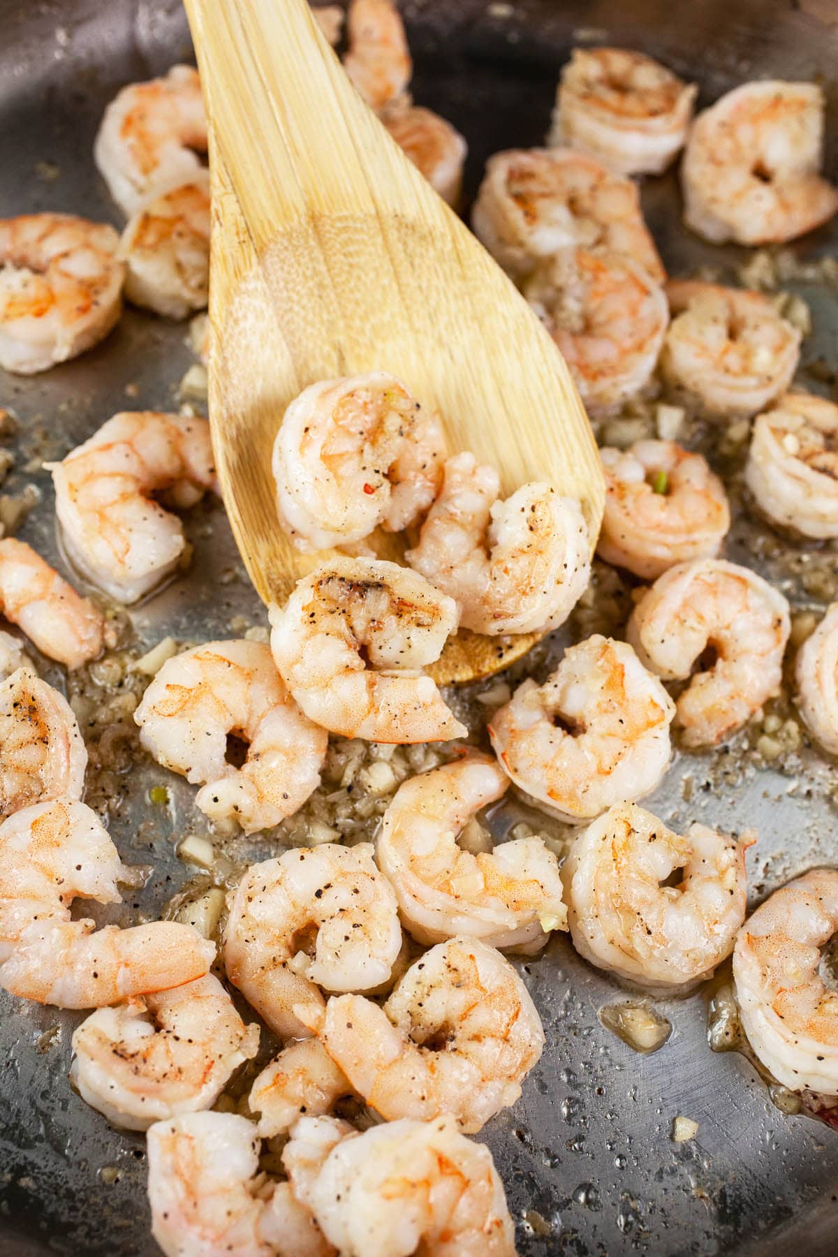 Shrimp sautéed with garlic in skillet. 