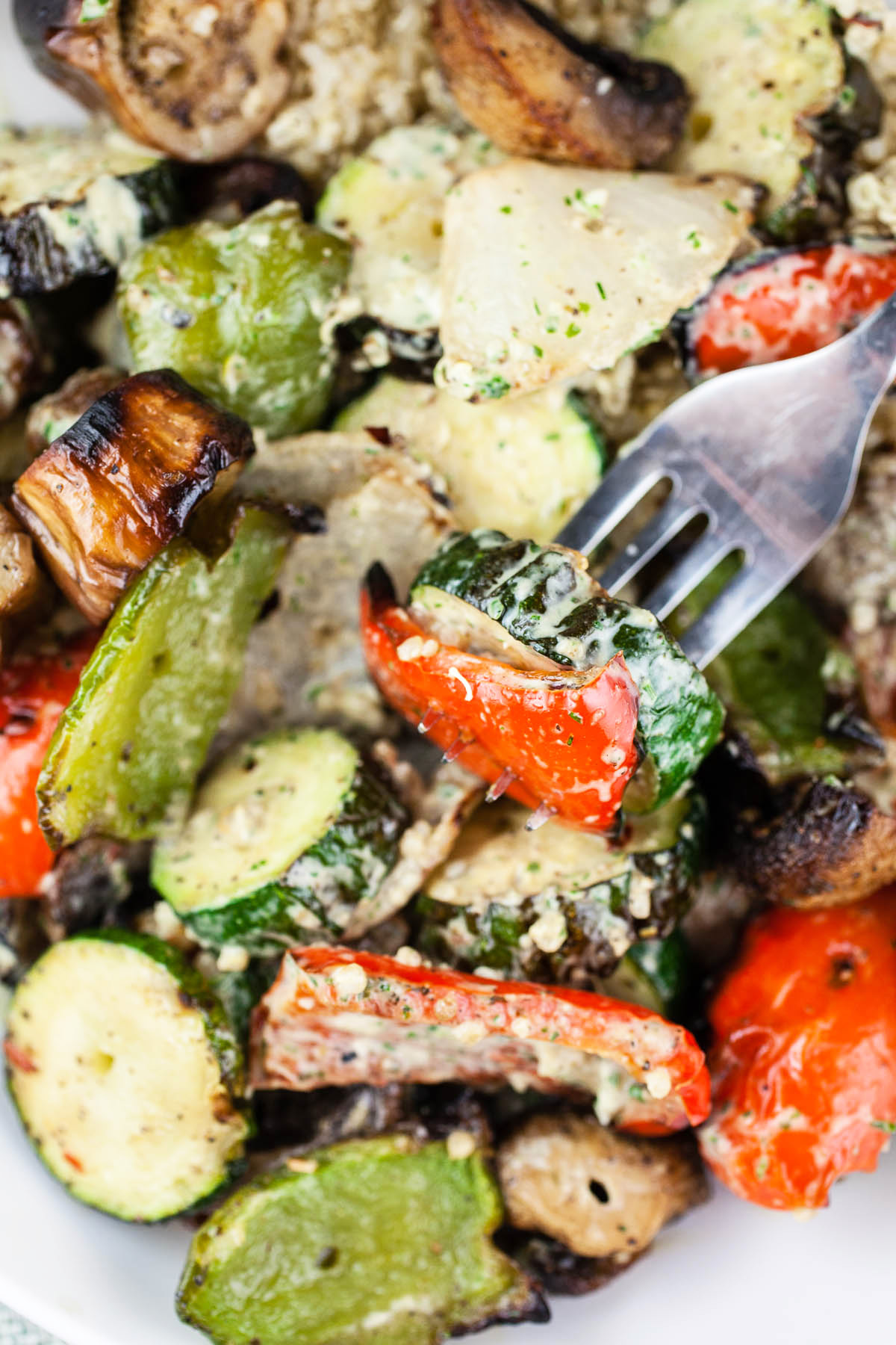 Roasted summer vegetable salad with fork.