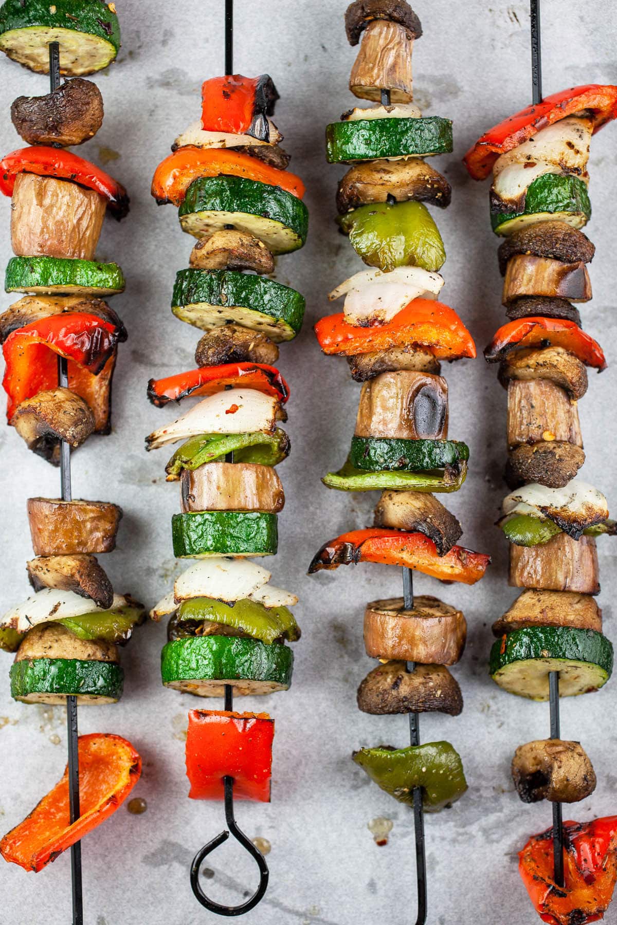 Grilled vegetables on metal skewers.