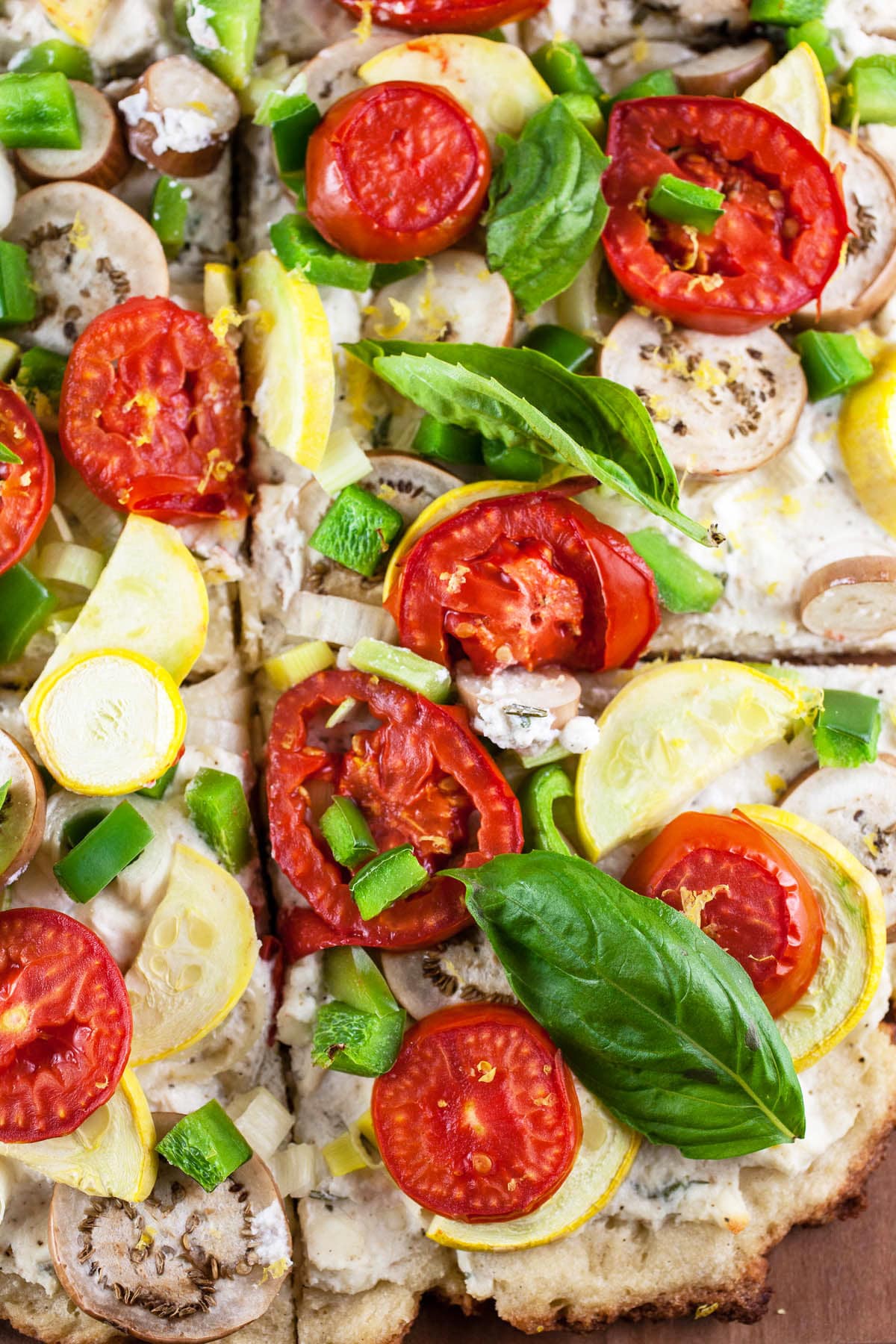 Farmers market vegetable pizza cut into slices.