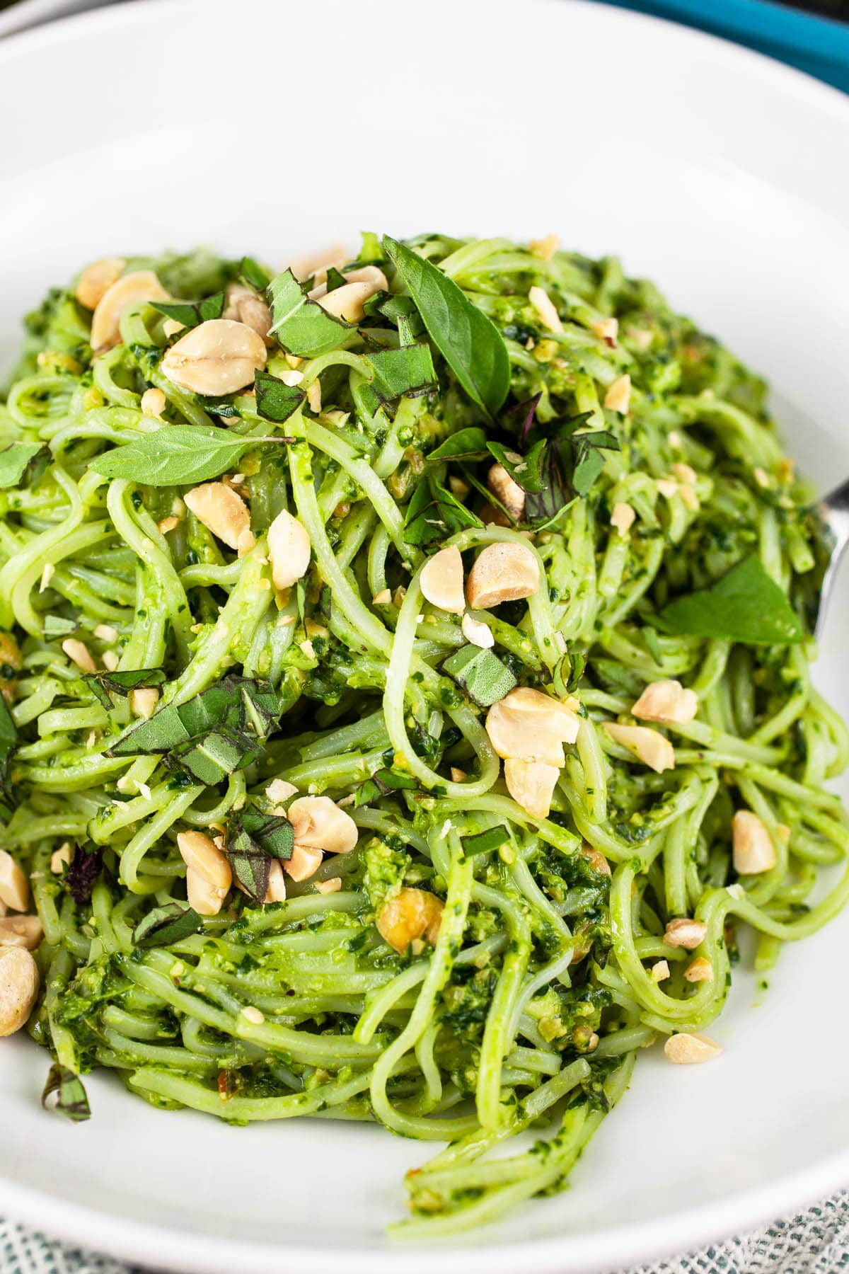 Thai basil pesto noodles in white bowl.