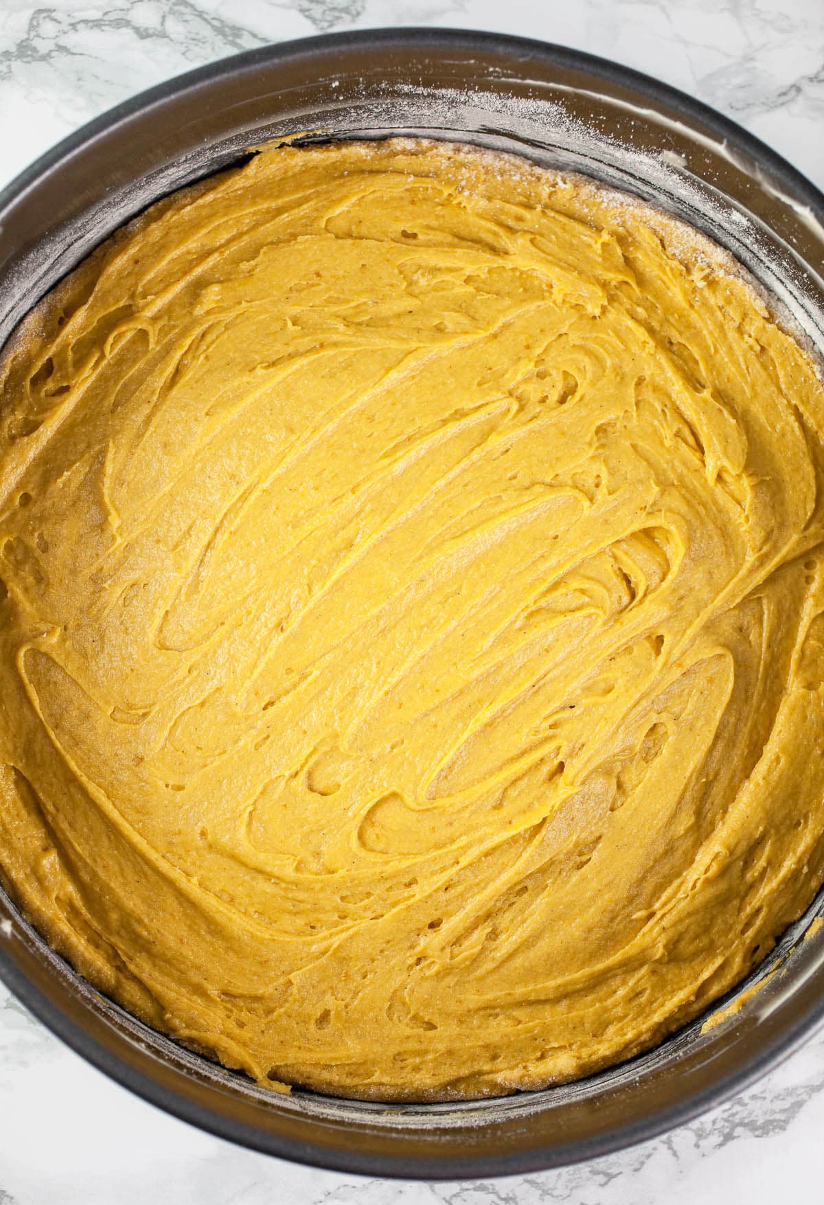 Pumpkin cake batter in springform pan.