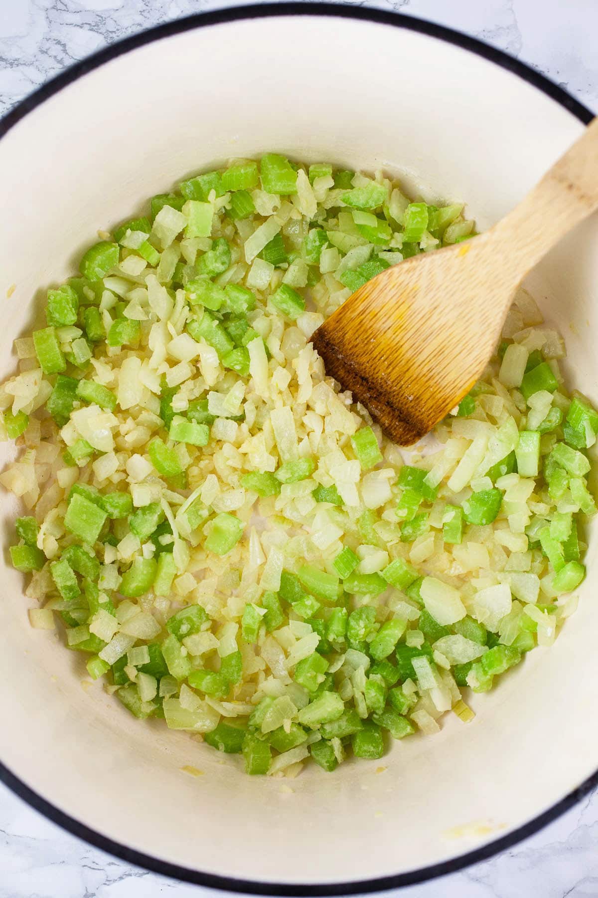 Garlic, onions, and celery sautéed with white wine in Dutch oven.