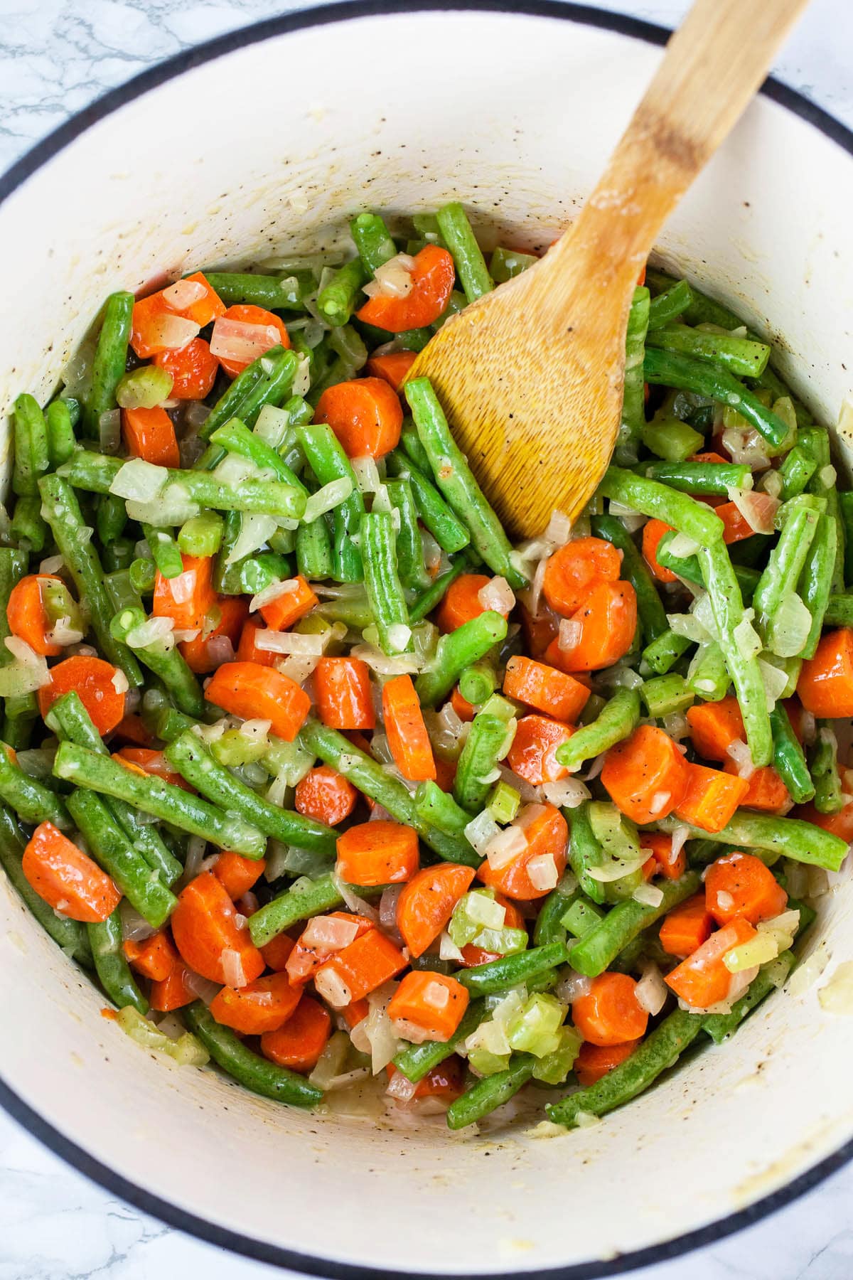 Garlic, onions, celery, carrots, and green beans sautéed in Dutch oven.