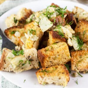 Fennel herb stuffing on white plate with fork.