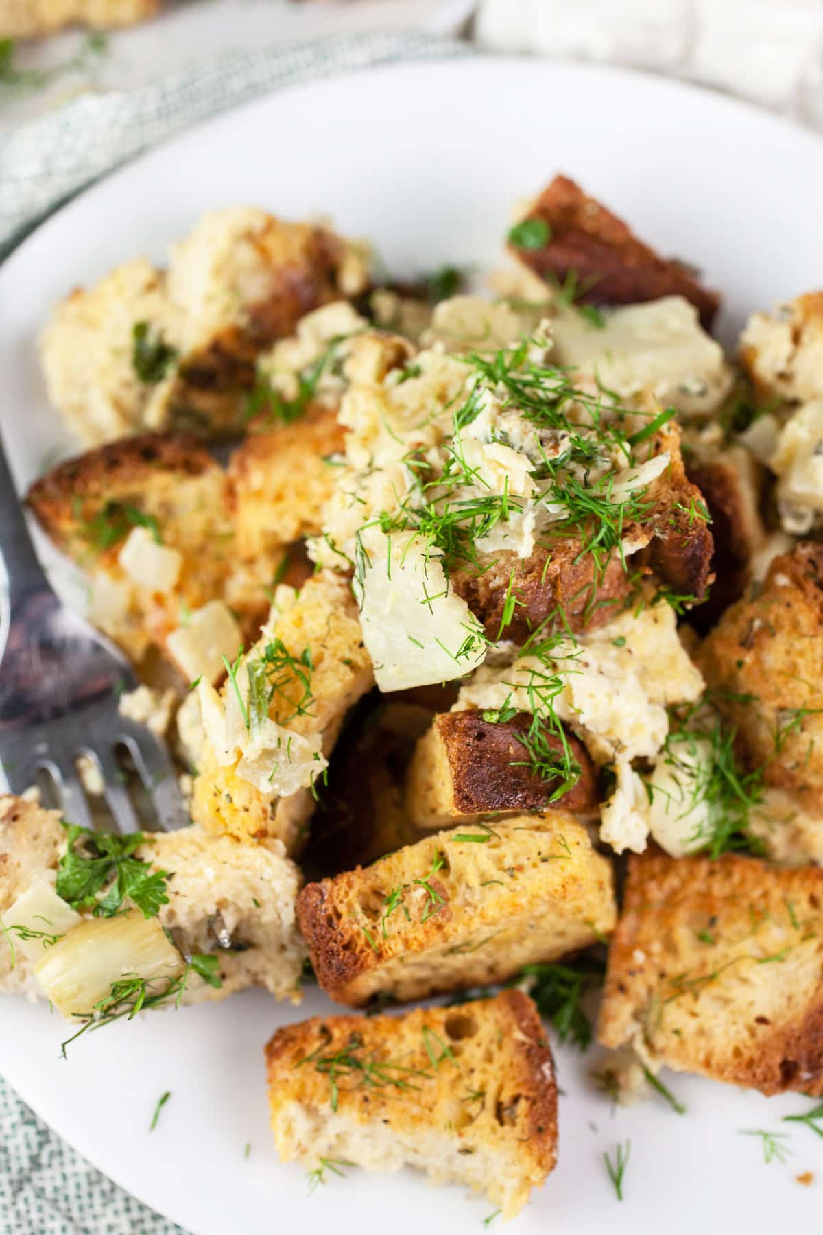 Fennel stuffing on white plate with fork.