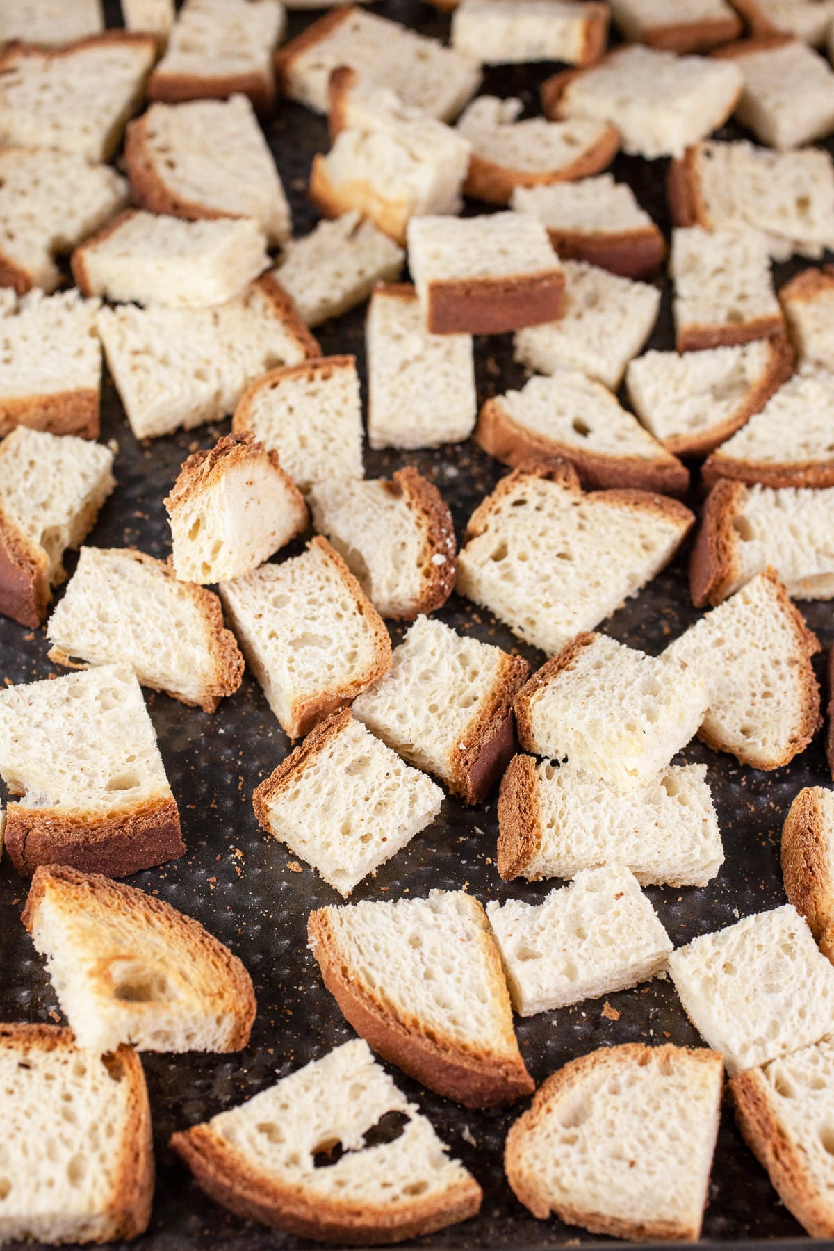 Toasted bread cubes on baking sheet.