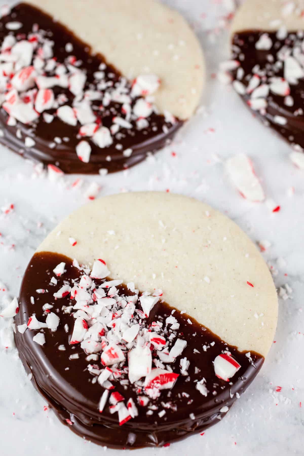 Peppermint shortbread cookies dipped in chocolate ganache and peppermint candies.