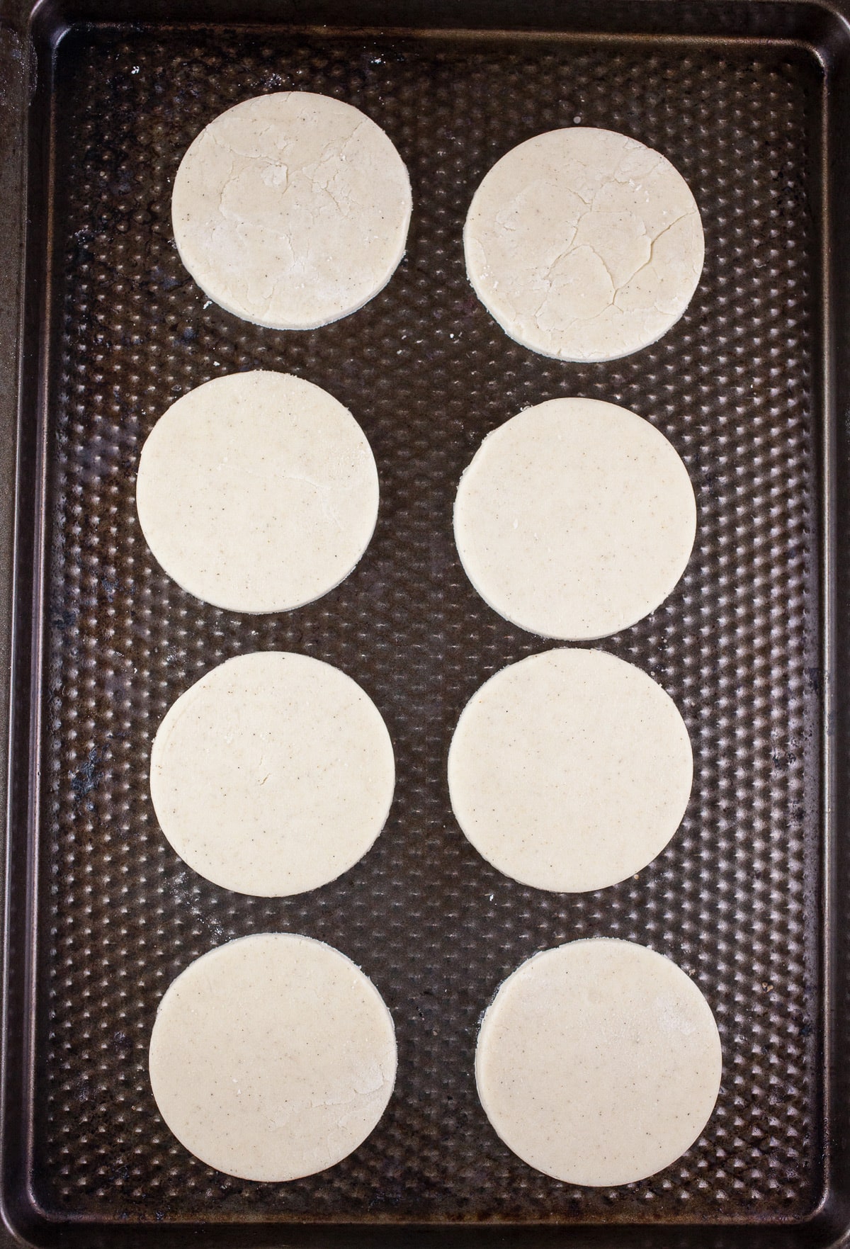 Unbaked shortbread cookies on baking sheet.