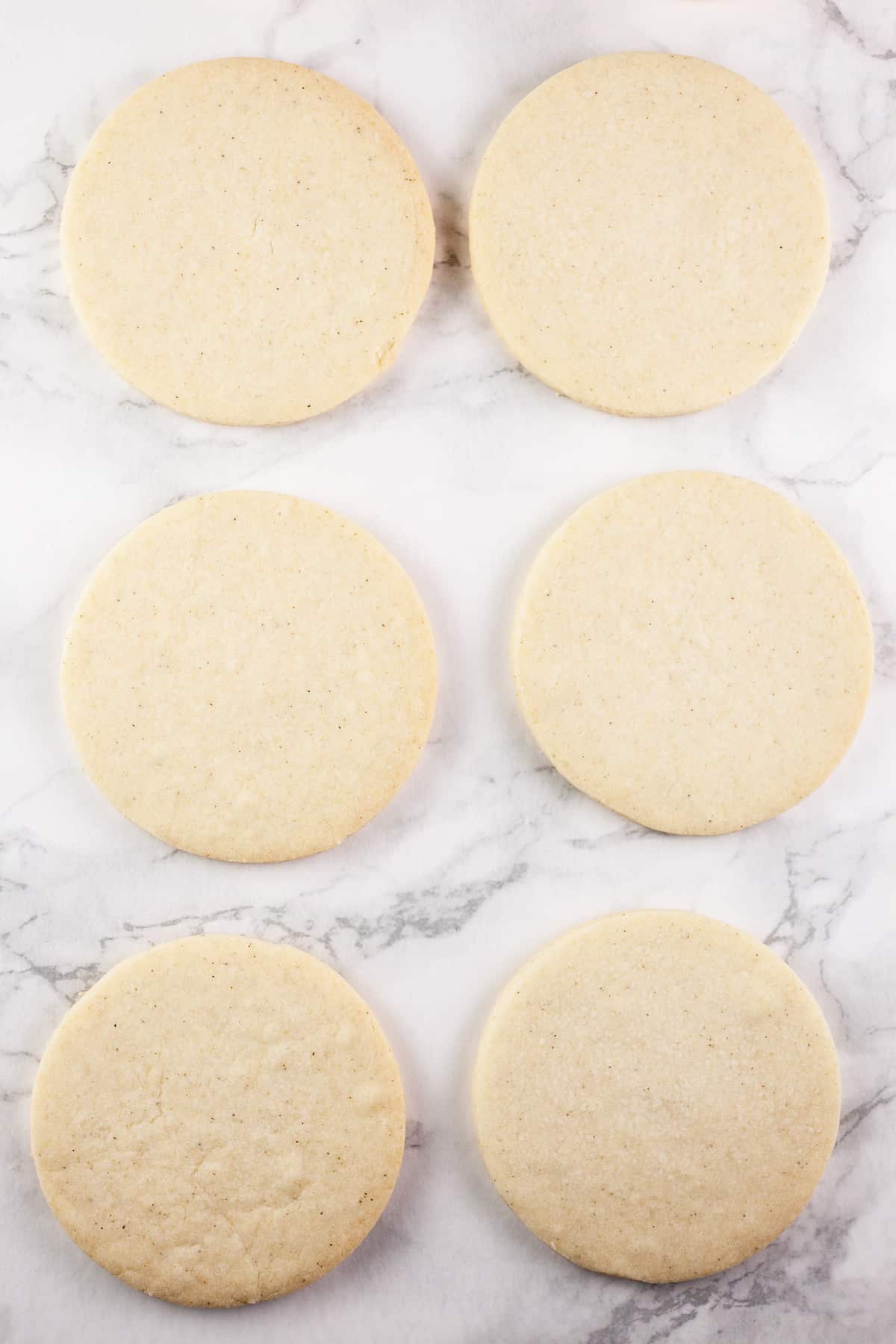 Baked shortbread cookies on white surface.