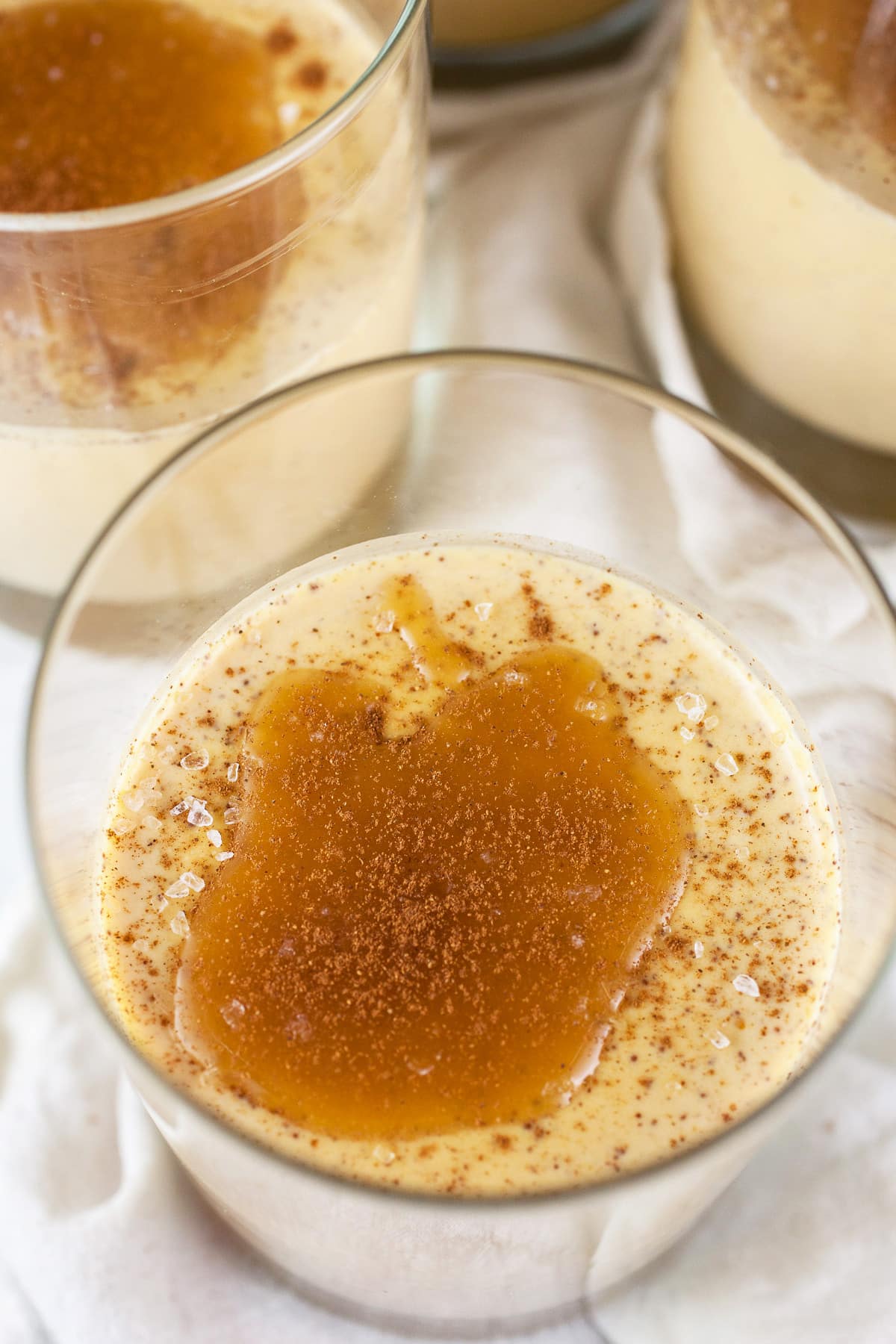 Pumpkin panna cotta with caramel sauce in small glasses.