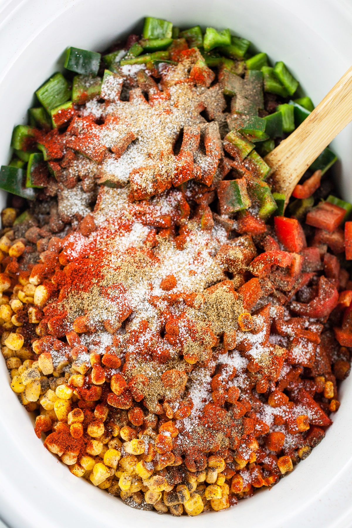 Chili ingredients and spices in slow cooker.