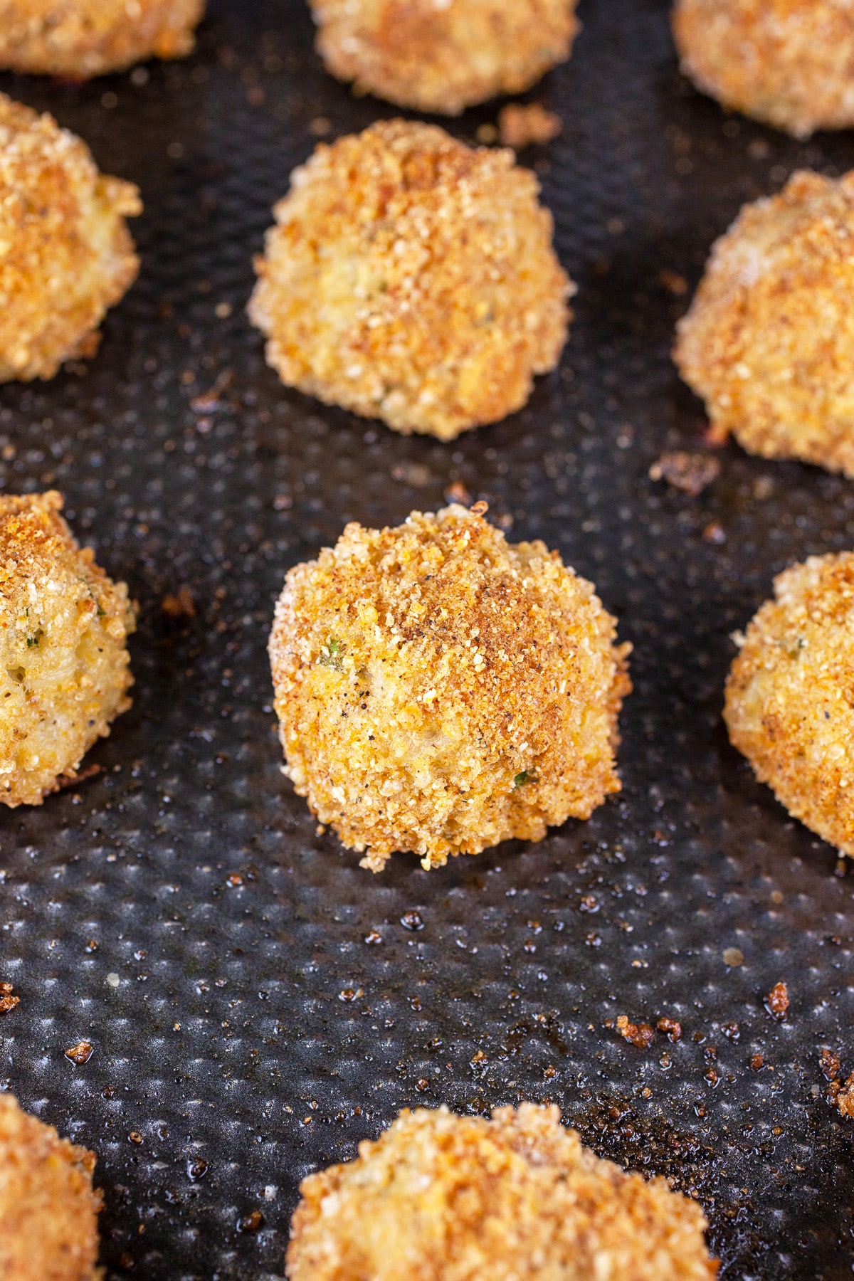 Baked rice balls on sheet pan.