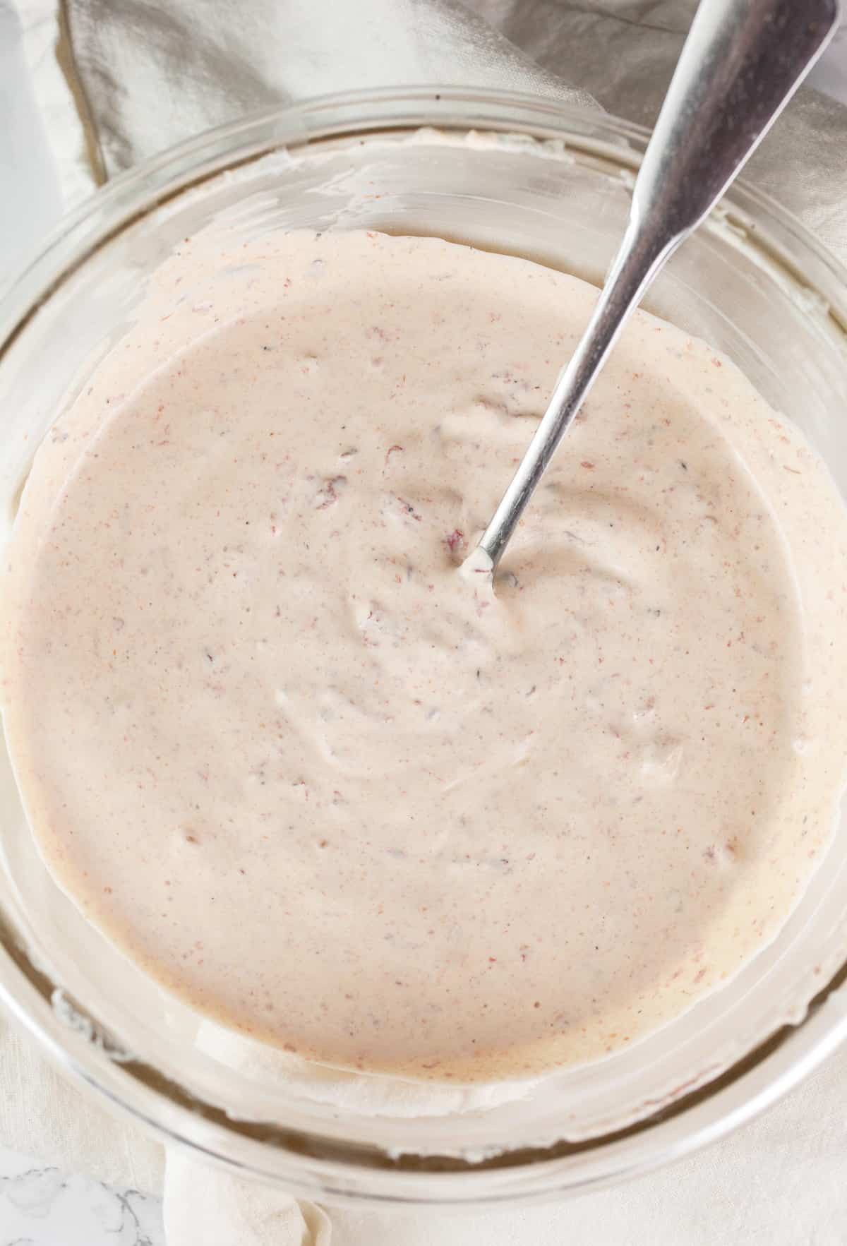 Chipotle sour cream in small glass bowl.