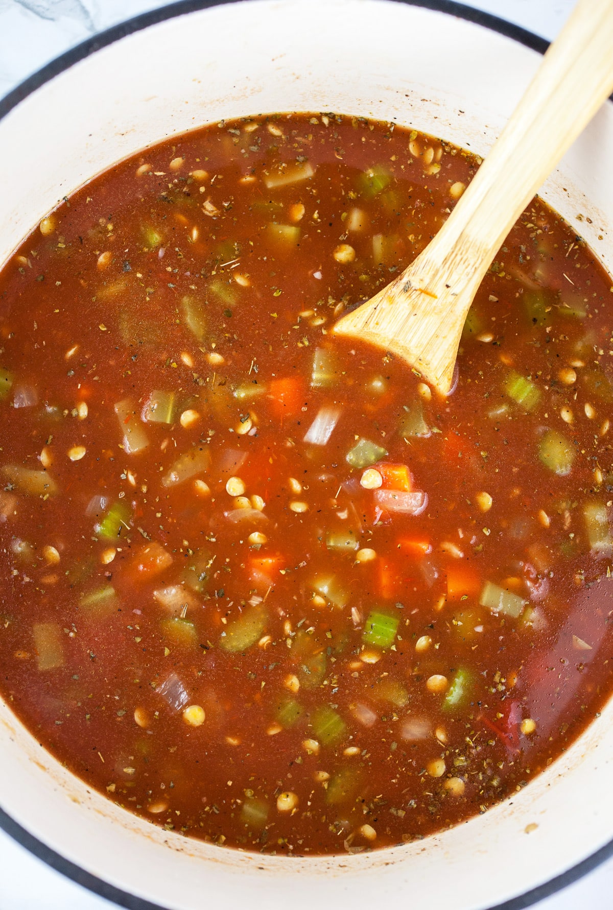 Uncooked lentil soup in Dutch oven.