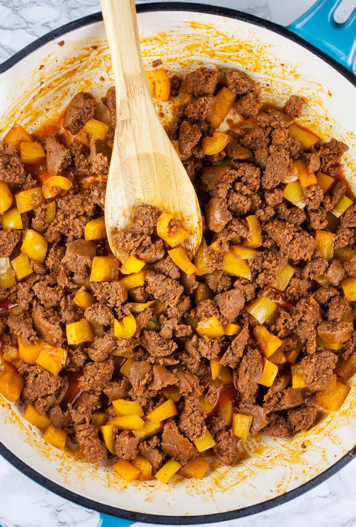 Diced yellow bell peppers and turkey chorizo sautéed in cast iron skillet.