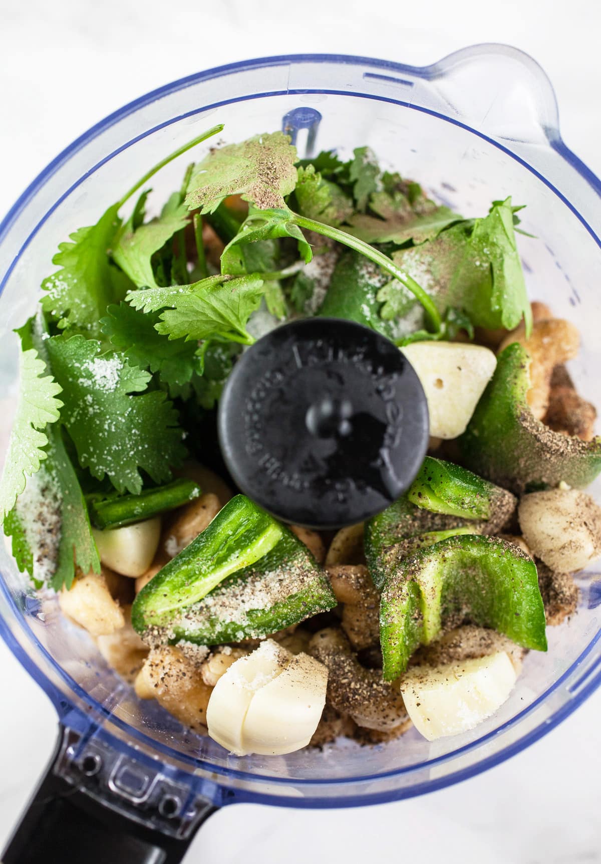 Cashews, jalapeno, cilantro, garlic, salt, pepper, and lime juice in food processor.