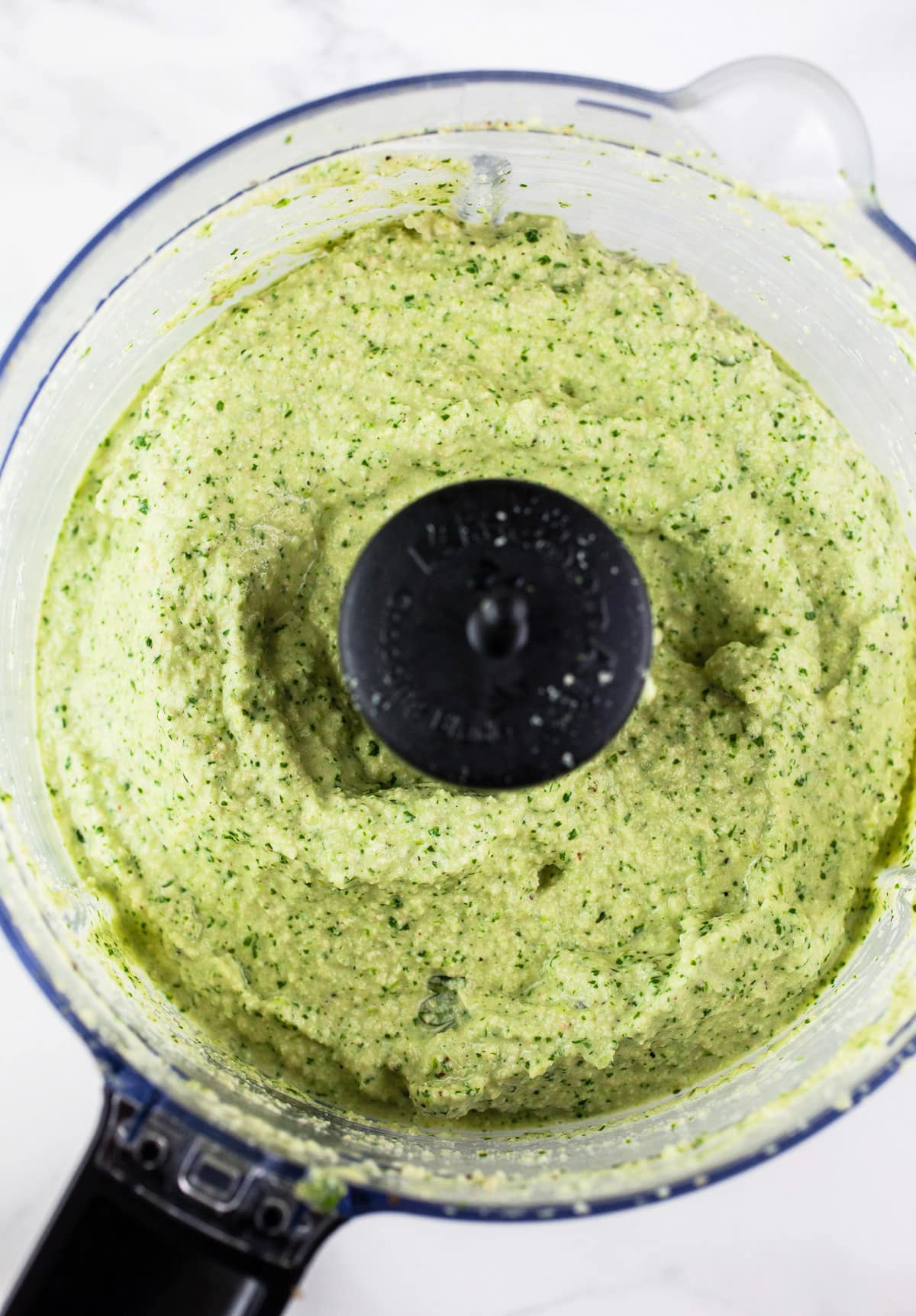 Cilantro cashew sauce pureed in food processor.