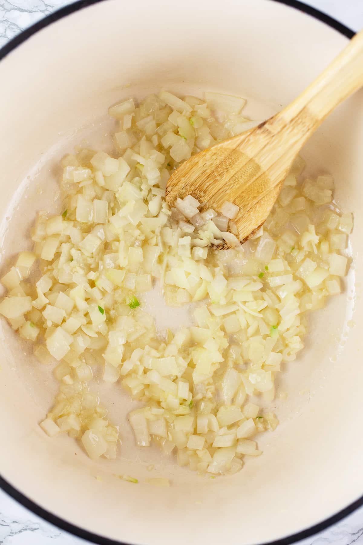 Minced garlic, onions, and ginger sautéed in Dutch oven.