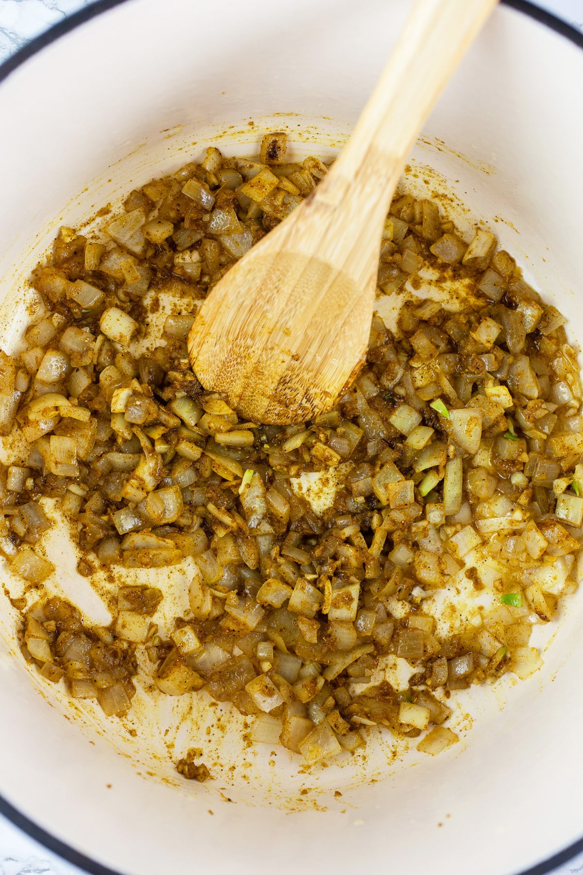 Minced garlic, onions, ginger, and spices sautéed in Dutch oven.