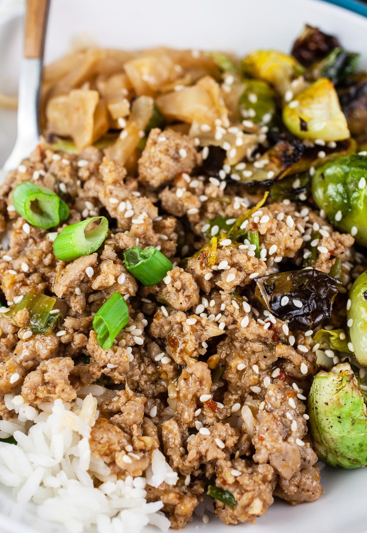 Korean ground turkey bowls with rice, kimchi, and Brussels sprouts.