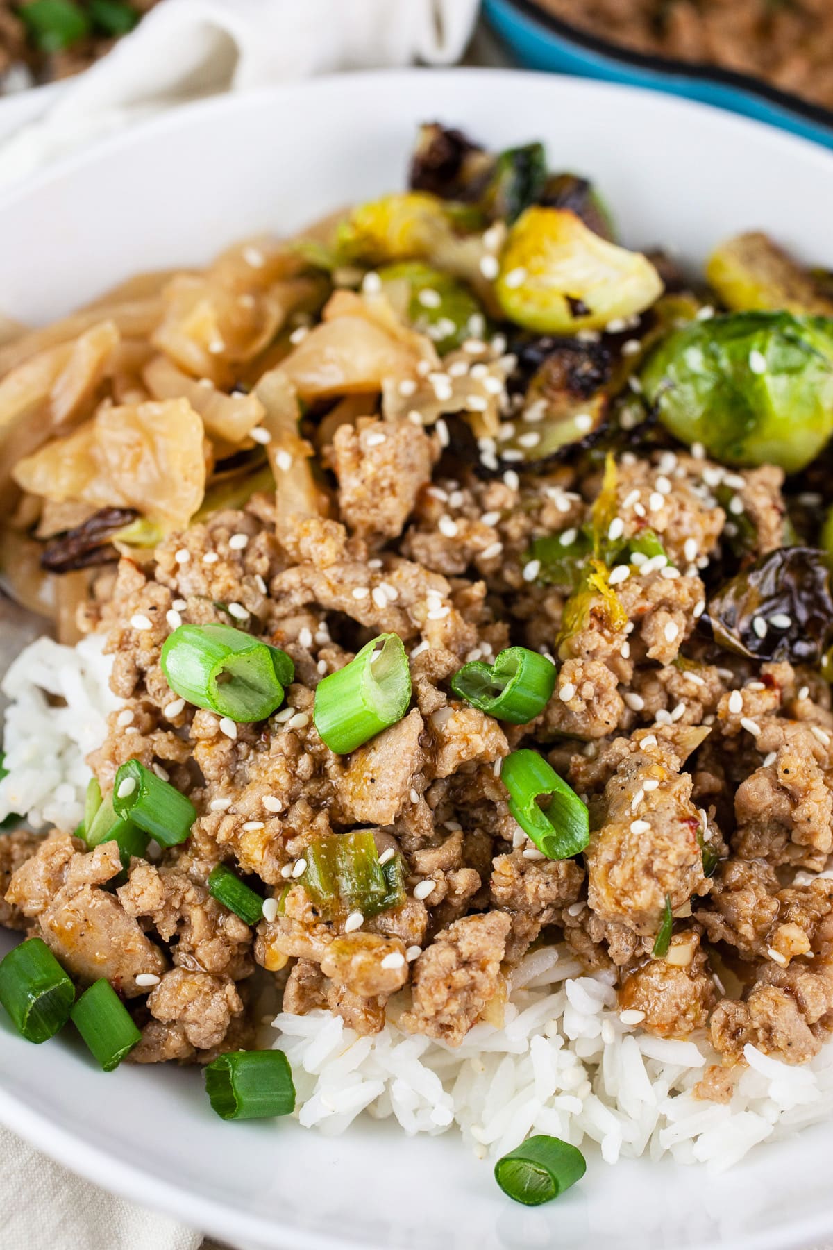 Korean turkey bowls with rice, kimchi, and Brussels sprouts in white bowl.