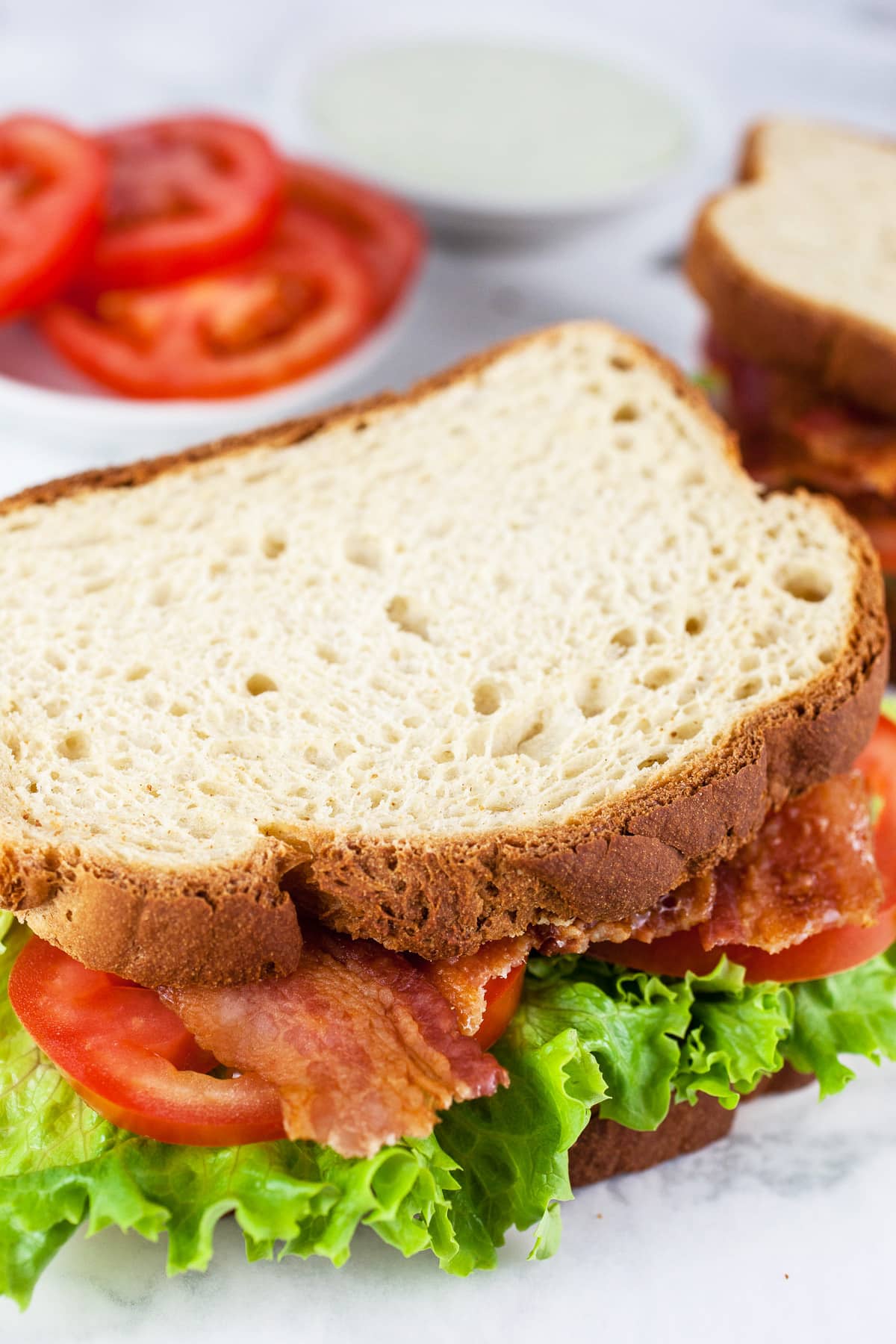 BLT sandwich with sliced tomatoes and lemon basil mayo sauce.