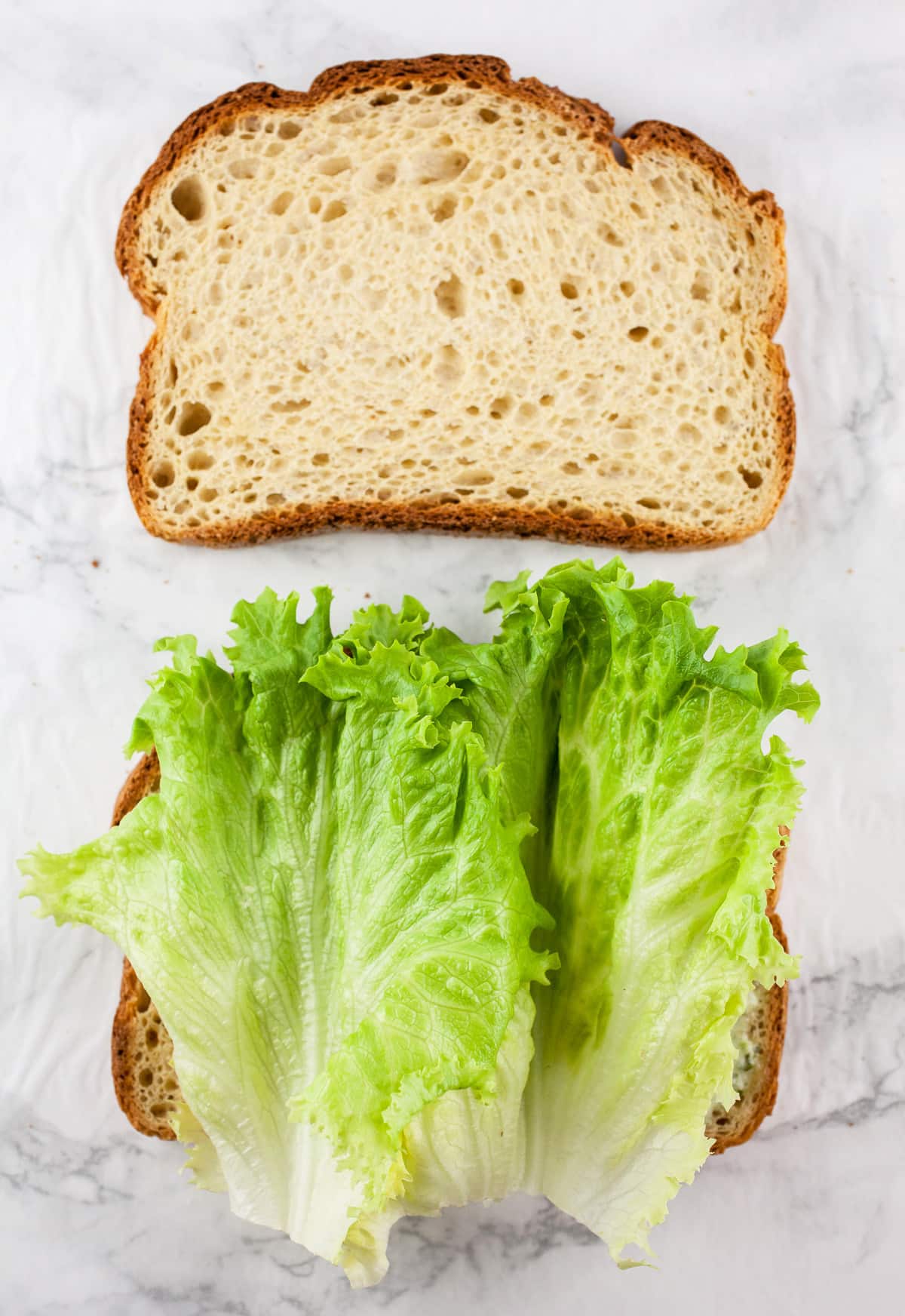 Bread slices with lettuce.