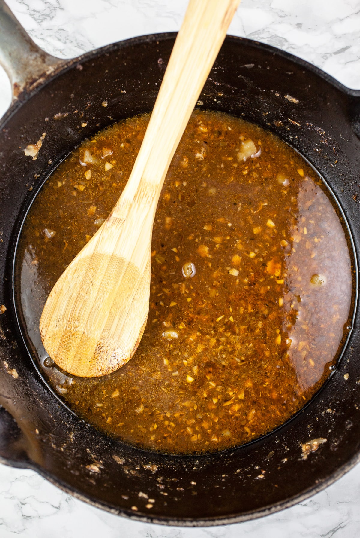 Chicken grease and spices in Dutch oven.