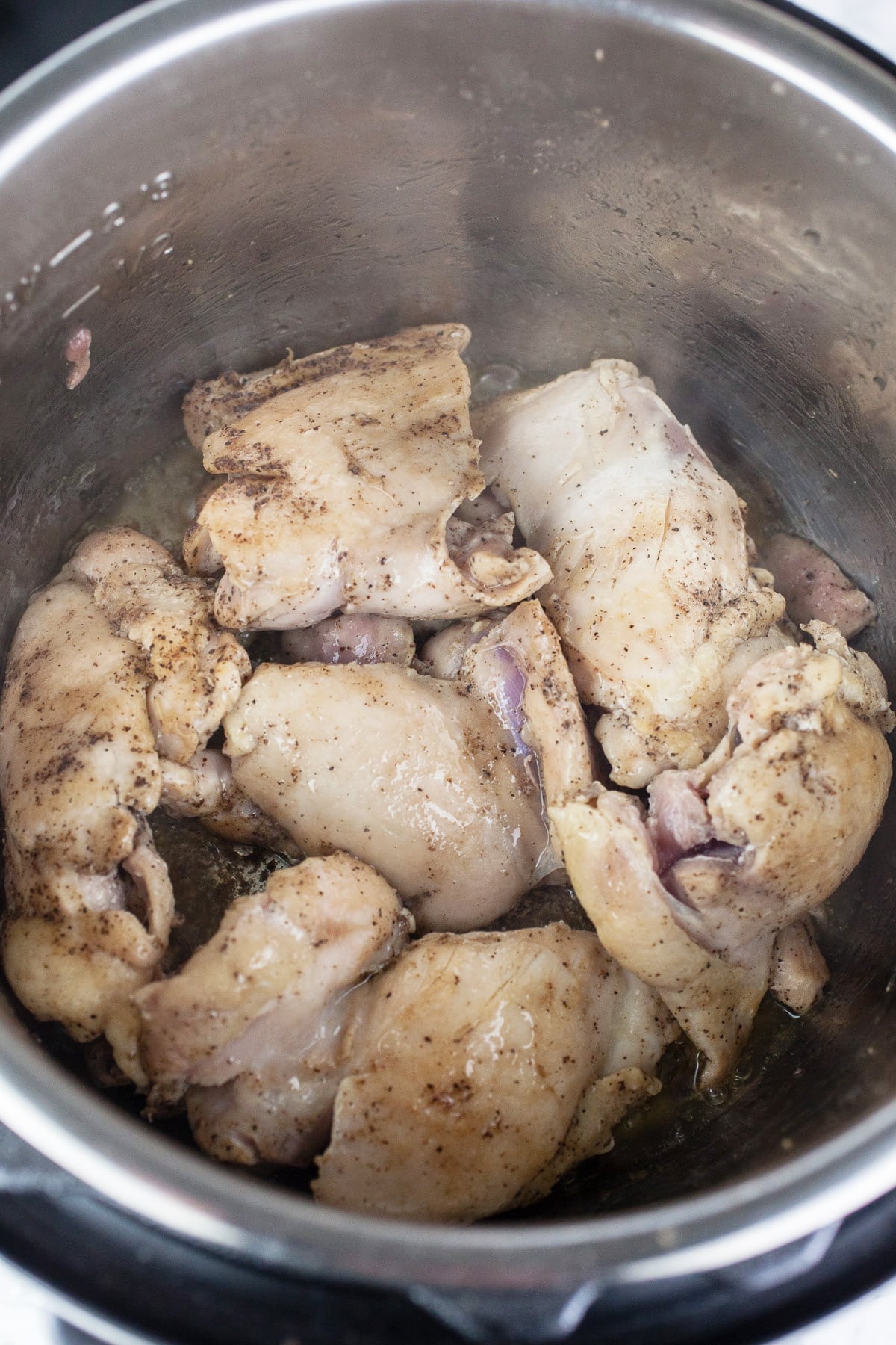 Chicken thighs sautéed in Instant Pot.